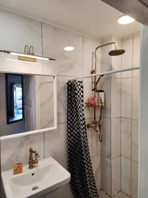 a bathroom with a sink and a shower at Comfort Mile Apartments in Vilnius