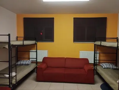 a living room with a couch and two bunk beds at Centro Hostel in Vilnius