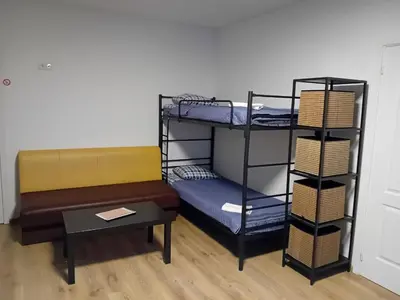 a room with two bunk beds and a bench at Centro Hostel in Vilnius