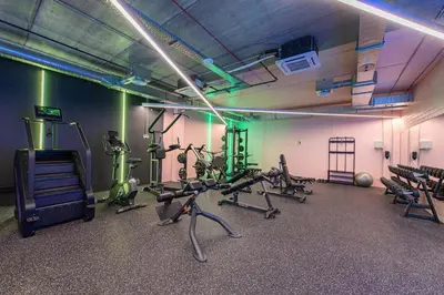 a gym with several treadmills and exercise bikes at SHED Vilnius Coliving in Vilnius