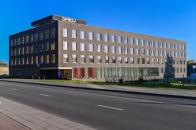 a large building on the side of a road at SHED Vilnius Coliving in Vilnius