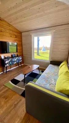 a room with a bed and a large window at Lake House in Anykščiai