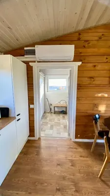 a room with wooden walls and a room with a ceiling at Lake House in Anykščiai