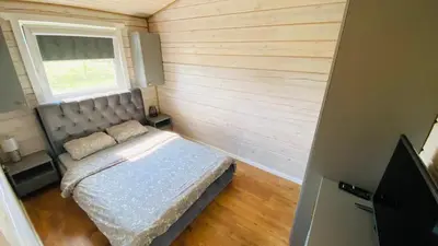 a small bedroom with a bed and a window at Lake House in Anykščiai