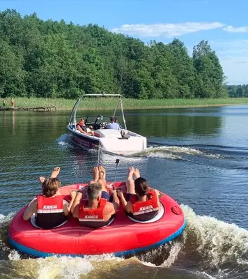 a group of people in a boat on the water at Lake House in Anykščiai