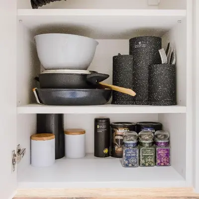 a pantry with a shelf filled with food and spices at Stylish Apartment in Zverynas in Vilnius
