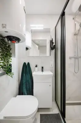 a bathroom with a toilet and a sink and a shower at Stylish Apartment in Zverynas in Vilnius
