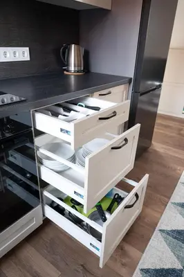 a kitchen with white drawers and a refrigerator at Cozy Central Attic SELF Check In in Vilnius