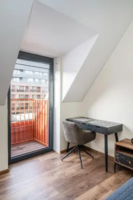 a room with a desk and a window at Cozy Central Attic SELF Check In in Vilnius