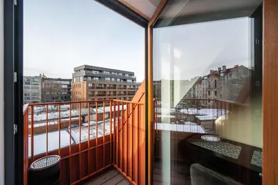 a balcony with a view of a city at Cozy Central Attic SELF Check In in Vilnius
