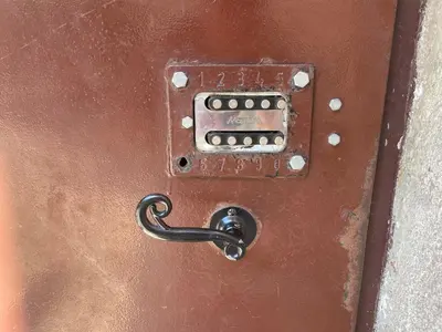 a metal door with a lock and a chain on it at Cozy Central Attic SELF Check In in Vilnius