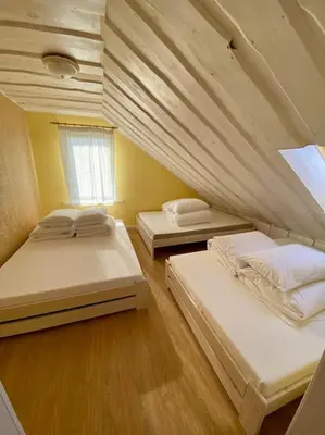three beds in a room with a attic at Homestead - Ukmergė area in Pabariškiai