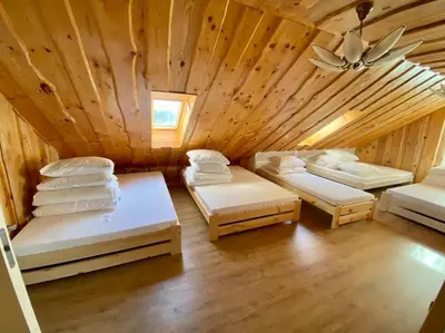 a room with three beds in a wooden cabin at Homestead - Ukmergė area in Pabariškiai