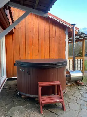 a hot tub with a stool in front of a building at Homestead - Ukmergė area in Pabariškiai
