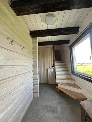 an empty room with stairs and a window at Homestead - Ukmergė area in Pabariškiai