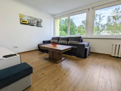 a living room with a couch and a table at Lovely 2-bedroom flat in the heart of Druskininkai in Druskininkai
