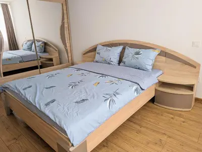 a bedroom with a bed with a blue comforter at Lovely 2-bedroom flat in the heart of Druskininkai in Druskininkai