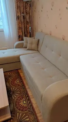 a living room with a large couch and a table at Rami nakvynė Panevėžyje in Panevėžys