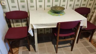 a table with four chairs and a bowl on it at Rami nakvynė Panevėžyje in Panevėžys