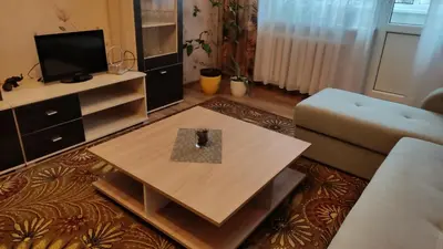 a living room with a coffee table and a couch at Rami nakvynė Panevėžyje in Panevėžys
