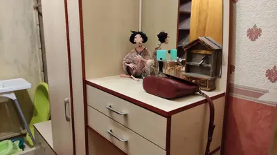 a doll sitting on a dresser in a room at Rami nakvynė Panevėžyje in Panevėžys