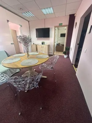 a conference room with a table and two chairs at Draugystės apartmentai in Kaunas