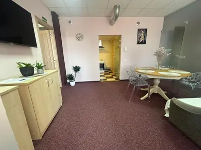 a room with a table and a dining room at Draugystės apartmentai in Kaunas