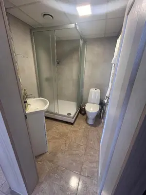 a bathroom with a shower and a sink and a toilet at Draugystės apartmentai in Kaunas
