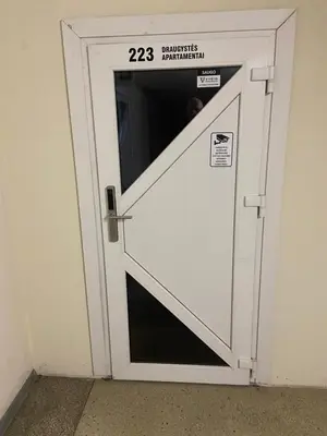a white door with a sign on it at Draugystės apartmentai in Kaunas