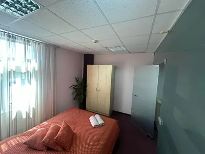 a bedroom with a bed with pillows and a window at Draugystės apartmentai in Kaunas