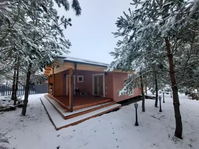a cabin in the woods in the snow at The Archers House in Viktariškės