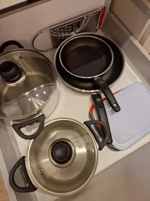 a stove top with pots and pans on it at Parko nauji apartamentai in Panevėžys