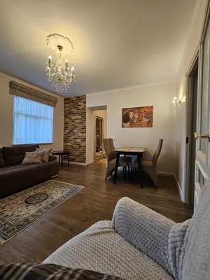 a living room with a couch and a table at Vilnius City Walls apartment in Vilnius