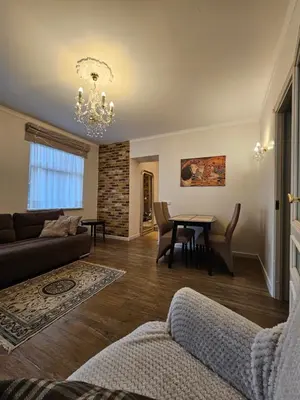 a living room with a couch and a table at Vilnius City Walls apartment in Vilnius