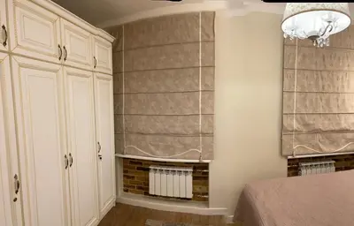 a bedroom with a bed and a window with curtains at Vilnius City Walls apartment in Vilnius