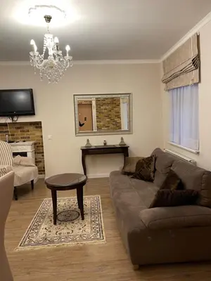 a living room with a couch and a table at Vilnius City Walls apartment in Vilnius