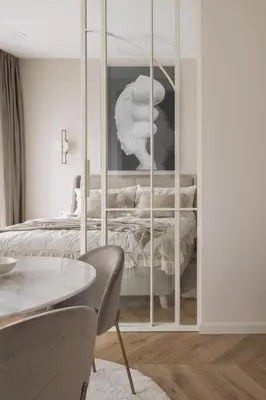 a living room with a bed and a table at IVIS House - Elegant Apartment with Church View in Vilnius Old Town in Vilnius