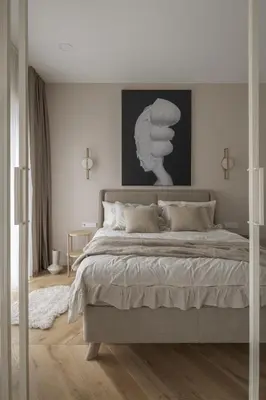 a bedroom with a large bed with a black and white picture at IVIS House - Elegant Apartment with Church View in Vilnius Old Town in Vilnius