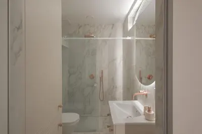 a bathroom with a shower and a sink and a toilet at IVIS House - Elegant Apartment with Church View in Vilnius Old Town in Vilnius