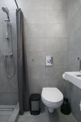 a bathroom with a shower and a toilet and a sink at Vilnius4you studio in Vilnius