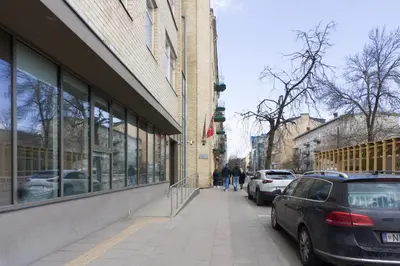 a street with cars parked in front of a building at Vilnius4you studio in Vilnius