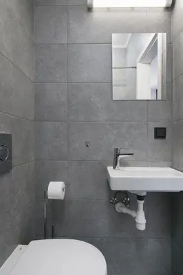 a bathroom with a sink and a toilet and a mirror at Vilnius4you studio in Vilnius