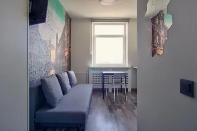 a living room with a couch and a table at Vilnius4you studio in Vilnius