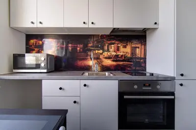 a kitchen with a sink and a microwave at Vilnius4you studio in Vilnius