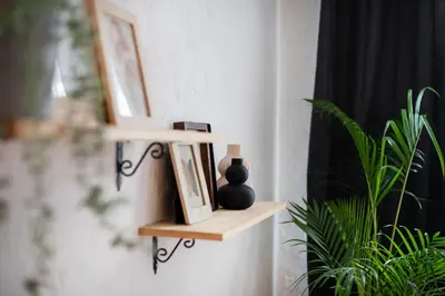 a shelf on a wall with a picture and a vase at #stayhere - Cozy 1BDR Apartment Vilnius Old Town in Vilnius