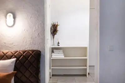 a room with a couch and a shelf with towels at #stayhere - Cozy 1BDR Apartment Vilnius Old Town in Vilnius