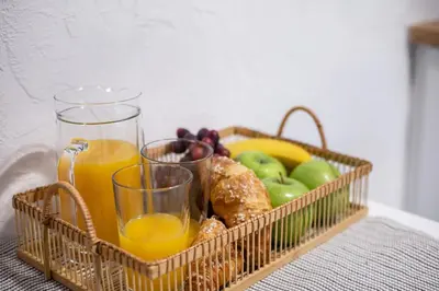 a basket of fruit and a glass of orange juice at #stayhere - Cozy 1BDR Apartment Vilnius Old Town in Vilnius