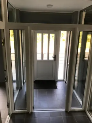 a hallway with sliding glass doors in a house at Klykių apartamentai in Klykiai