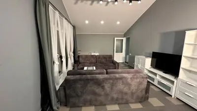 a living room with two couches and a television at Klykių apartamentai in Klykiai