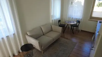 a living room with a couch and a table at Žalio kalno apartamentai in Kaunas